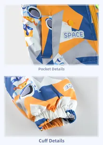 Detail of side pockets and elastic cuffs on a blue space-themed kids' zip-up jacket