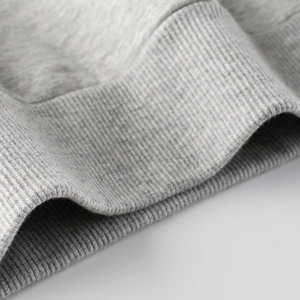 Close-up of gray ribbed cuffs on cotton blend sweatshirt showing premium fabric texture