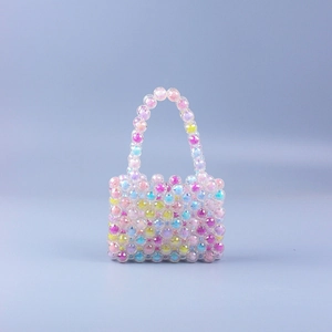 Macro detail of multi-colored translucent acrylic beads and handmade weave on mini handbag