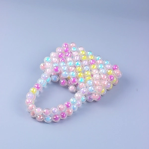 Macro detail of handmade iridescent acrylic beaded mini handbag with rainbow crystal finish