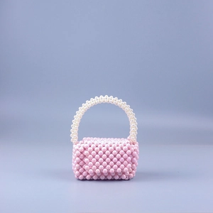 Detail of handmade mini pearl beaded handbag with pink and white iridescent acrylic beads
