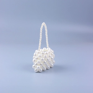 Handmade white faux pearl beaded mini handbag featuring a sleek semicylindrical design