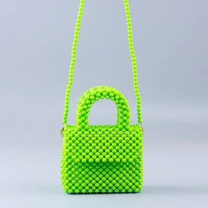 Detailed view of neon green handmade acrylic beaded handbag with crossbody strap