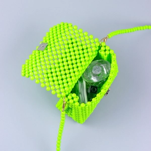 Neon green handmade beaded tote bag with silver metal lock showing interior capacity