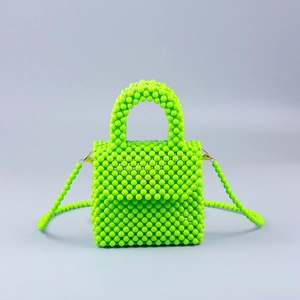 Detail of neon green handmade beaded mini bag with glossy finish and detachable strap