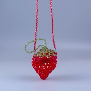 Mini strawberry beaded crossbody bag with red acrylic pearls and green leaf detail