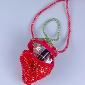 Mini acrylic strawberry beaded crossbody bag with green leaf detail and a red chain strap