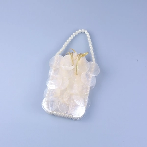 Detailed view of handmade pearl beaded evening bag with shimmering fish scale sequins