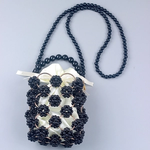 Handmade beaded mini handbag with black pearls and white satin drawstring pouch inside