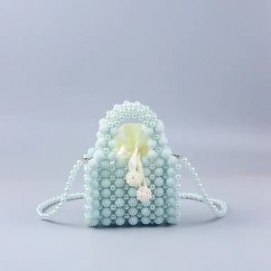 Detail of handmade blue and white pearl beaded bag with satin drawstring liner