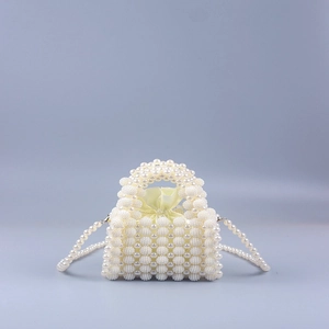 Detailed view of the handmade pearl beaded clutch with a yellow satin drawstring liner