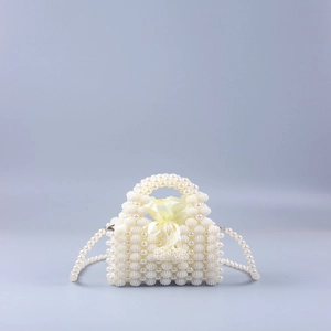 Detail of handmade mini pearl beaded handbag with yellow satin drawstring pouch liner