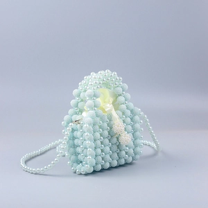 Detail of light blue handmade pearl beaded bag with yellow silk drawstring liner
