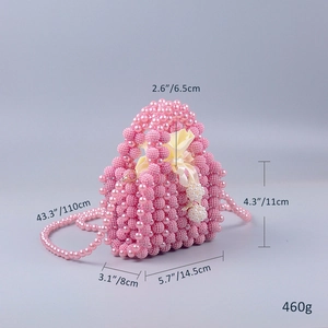 Detail of pink handmade beaded handbag with satin drawstring pouch and long bead chain