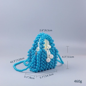 Detailed view of handmade blue beaded handbag with dimensions and white satin lining