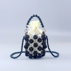Handmade black beaded bucket bag with cream satin drawstring lining and pearl shoulder strap