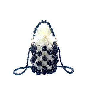 Handmade black beaded bucket bag with white satin drawstring lining and metal ring handle