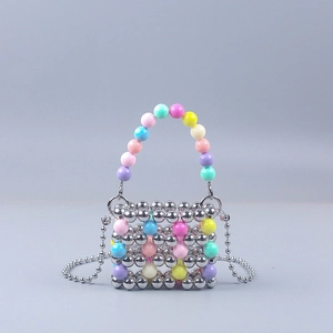 Detail of colorful acrylic beads and metallic chain on a handmade mini crossbody bag