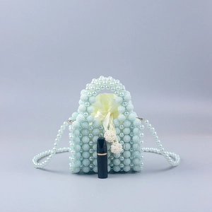Mini handmade pearl beaded handbag in light blue with yellow satin drawstring pouch