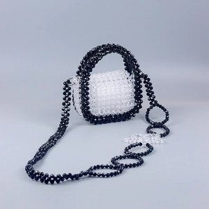 Detailed shot of handmade mini beaded handbag with black and white checkered bead patterns