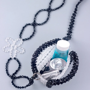 Detailed close-up of handmade acrylic bead bag with crystal texture and star chain