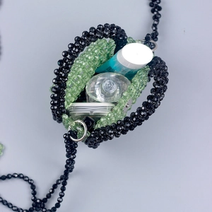 Handmade beaded mini crossbody bag with light green beads showing internal capacity