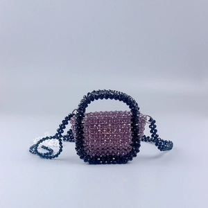 Handmade beaded mini crossbody bag in lilac acrylic beads with black flower-shaped straps