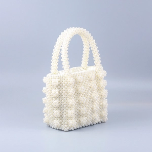 Detailed view of handmade pearl beaded handbag with elegant drawstring satin lining