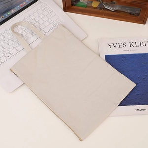 Detailed view of beige canvas A4 document bag with smooth zipper and textile handles