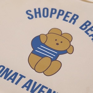 Detail of A4 canvas bag showing a cute cartoon bear print and fine oxford fabric texture