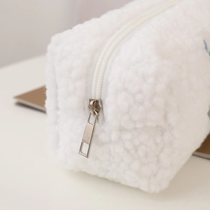 Macro shot of white fuzzy fleece texture and durable silver metal zipper detail