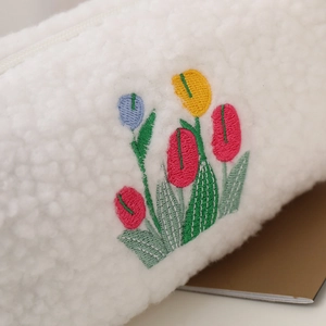 Cute white plush makeup bag with colorful tulip embroidery and soft fleece texture