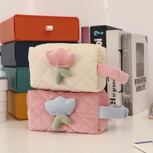 Quilted corduroy tulip makeup bags in pink and beige colors with carry handles