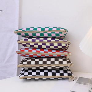 Close-up of five checkered canvas pencil cases stacked in various vibrant color schemes