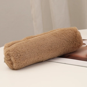 Detail of plush brown cylindrical pencil case showing soft faux fur texture and metal zipper
