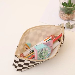 Checkerboard canvas pencil case with large capacity and zipper closure on a desk
