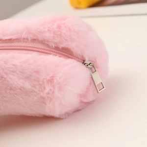 Detailed close-up of soft pink faux fur material and smooth metal zipper on pencil case