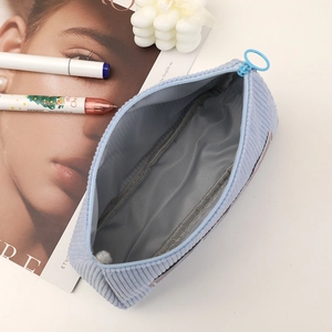 Macro view of blue corduroy pencil case interior showing soft lining and zipper detail