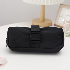 Detail of a black cylindrical pencil case featuring a heavy-duty buckle strap and zipper