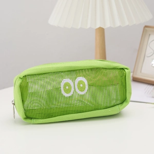 Macro detail of a green mesh pencil case featuring cute embroidered big eyes and zipper