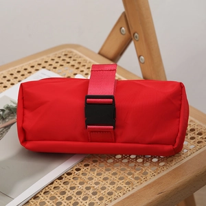 Minimalist red large capacity pencil case with durable fabric and buckle on woven background
