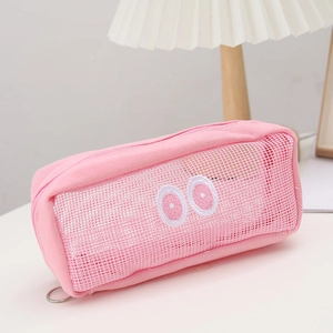 Close-up of pink mesh pencil case with big eye embroidery on white desk