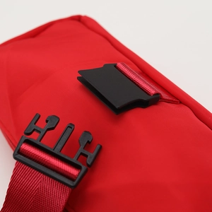 Close-up of durable red nylon fabric with black high-strength plastic buckle detail