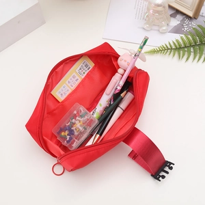 Detailed interior of red nylon pencil case with mesh pocket and stationery storage