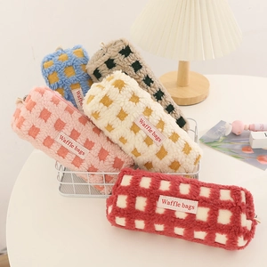 Plush waffle-textured pencil bags in five colors with 'Waffle bags' fabric label