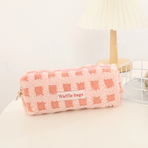 Detail of pink waffle fleece pencil case with soft texture and zippered closure