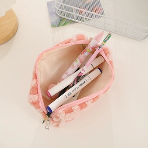 Close-up of pink checkered plush pencil case with zipper and lamb wool texture