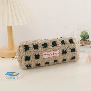 Detail of waffle fleece pencil case with green checkerboard pattern and fabric label