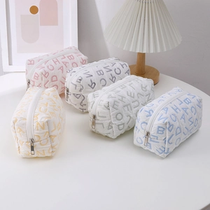 Minimalist canvas quilted pouches with letter prints in pink, grey, yellow, and blue colors