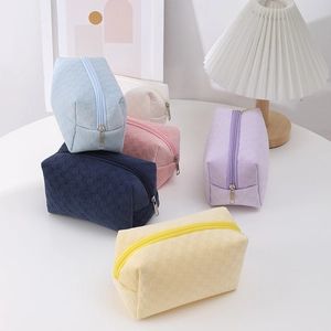 Multi-colored checkerboard pencil cases in a stackable aesthetic desk arrangement